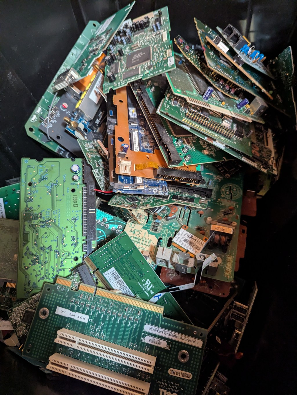 A box of miscellaneous circuit boards taken from recycled computers